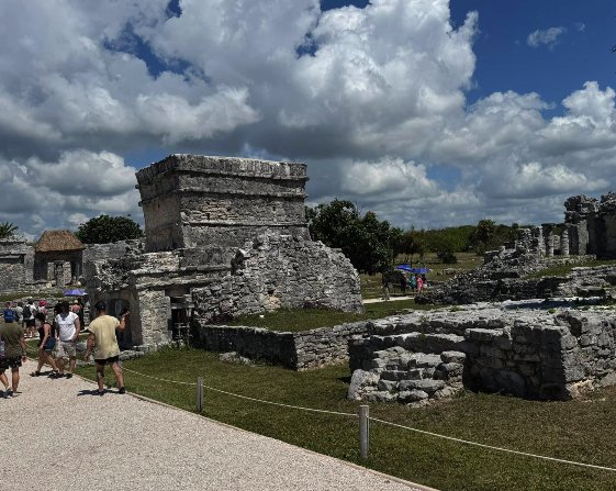 Private guide with visitors at the Tulum archaeological site